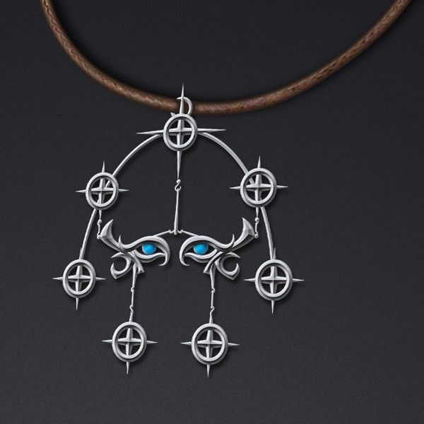 a silver necklace with blue eyes hanging from it's center on a leather cord