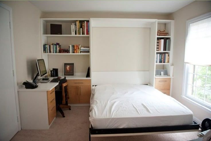 a bedroom with a bed, desk and bookshelf