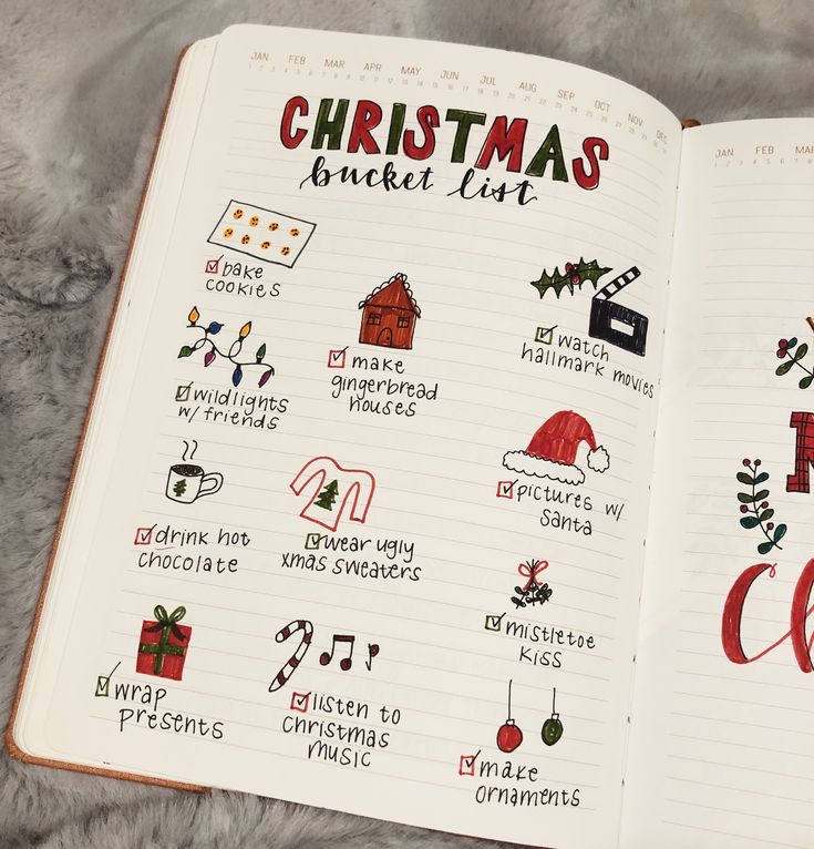 an open notebook with christmas stickers on the pages and handwritten words in red