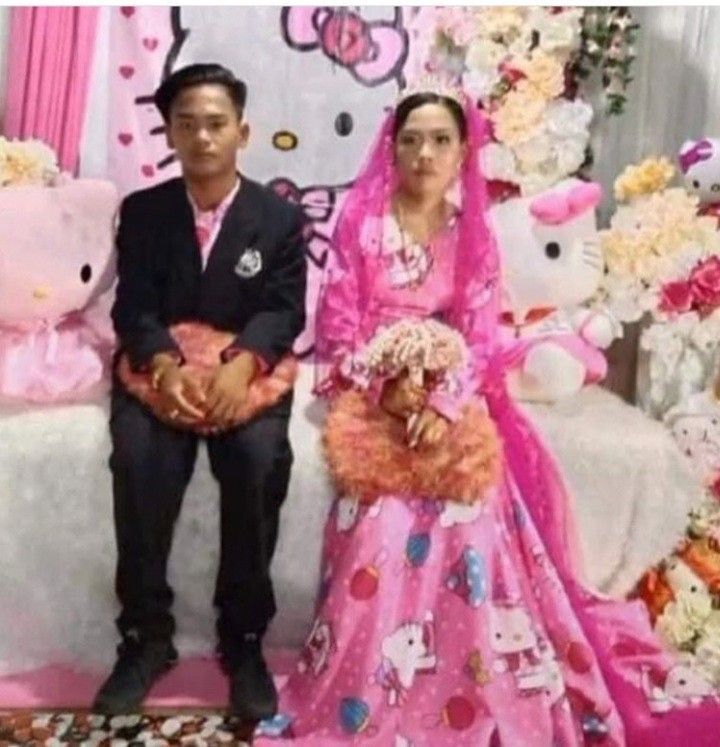 a man and woman sitting next to each other in front of a hello kitty backdrop