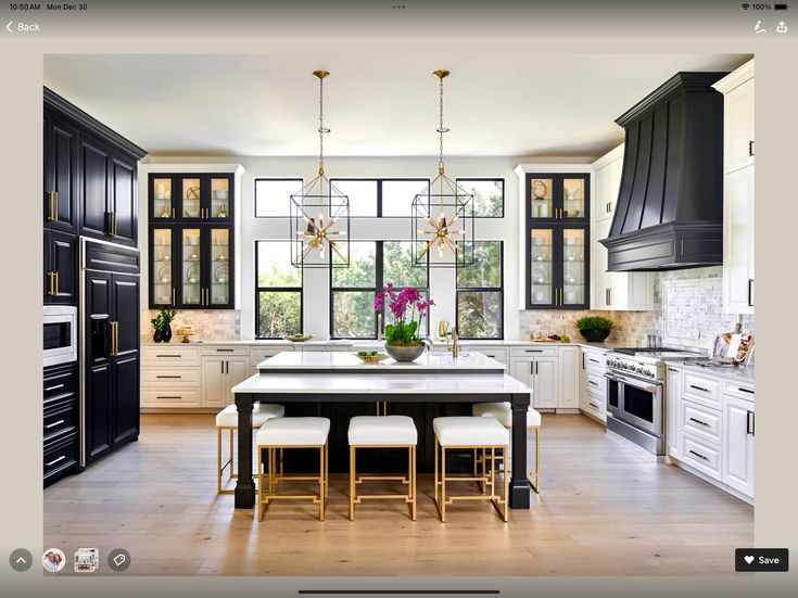 a kitchen with black cabinets and white counter tops