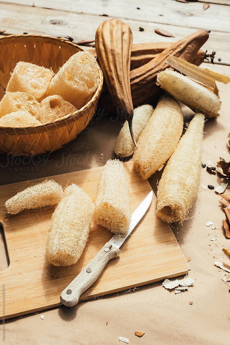 some kind of bread sitting on top of a wooden cutting board next to a knife