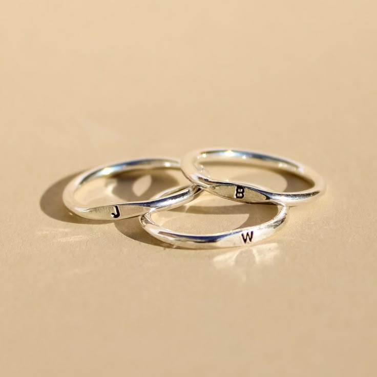 Handstamped with teeny tiny 1mm letters, this ring' truly stands out from the rest. Stack it with initials of your loved ones, or can be worn solo. The teeny tiny letters make it so special and unique. Crafted with quality sterling silver / 14k gold filled, our jewelry is made to last, to ensure its longevity Each letter is carefully handstamped with love. Metal: 14k Gold Filled or Sterling Silver Size: 3-13 Custom Information: Choose 1 initial (capital letters only) Packaging: Packaged in our l Initial Ring Silver, Silver Ring Designs For Girl, Ring Inspo Jewelry Silver, Ring With Letter, Pinky Promise Ring, Signet Ring Silver, Silver Initial Ring, Minimalist Wedding Rings, Ring Initial