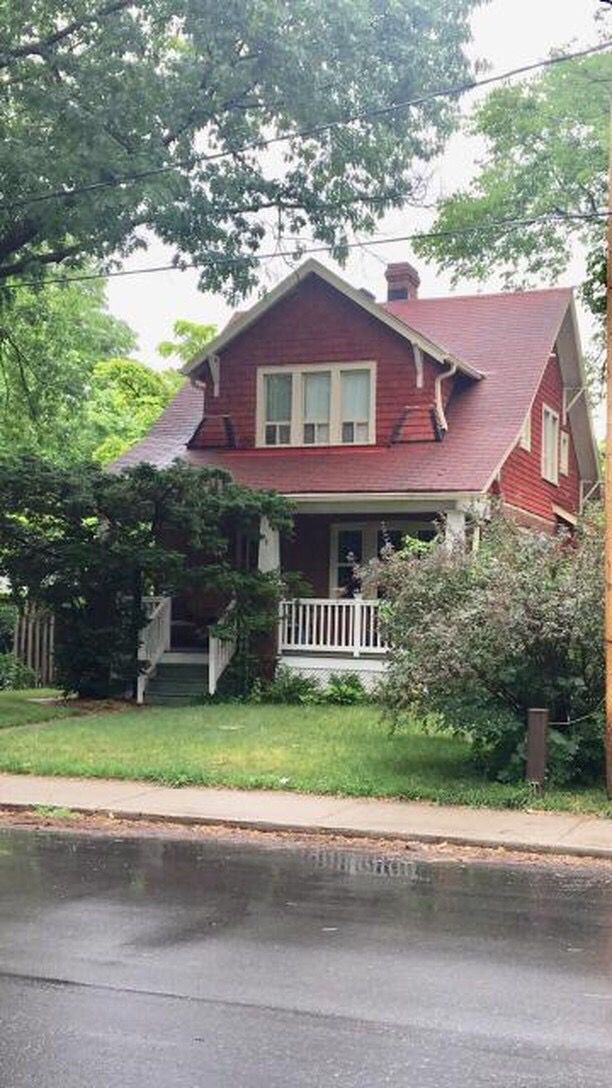 a red house sitting on the corner of a street