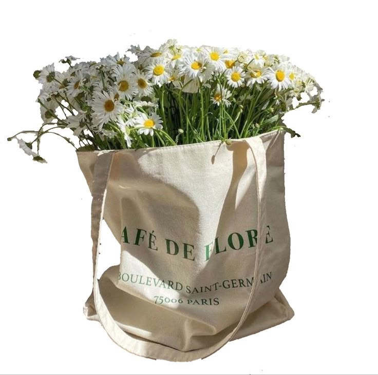 a bag filled with white daisies on top of a table