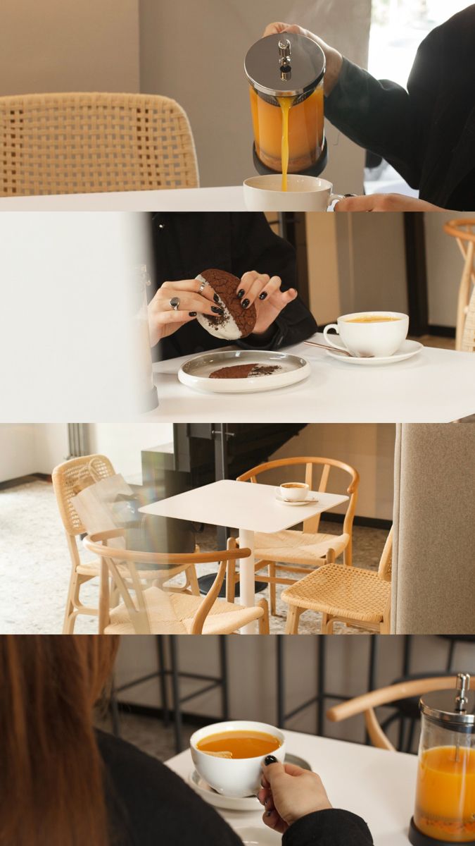 a woman sitting at a table eating food and drinking orange juice from a coffee pot