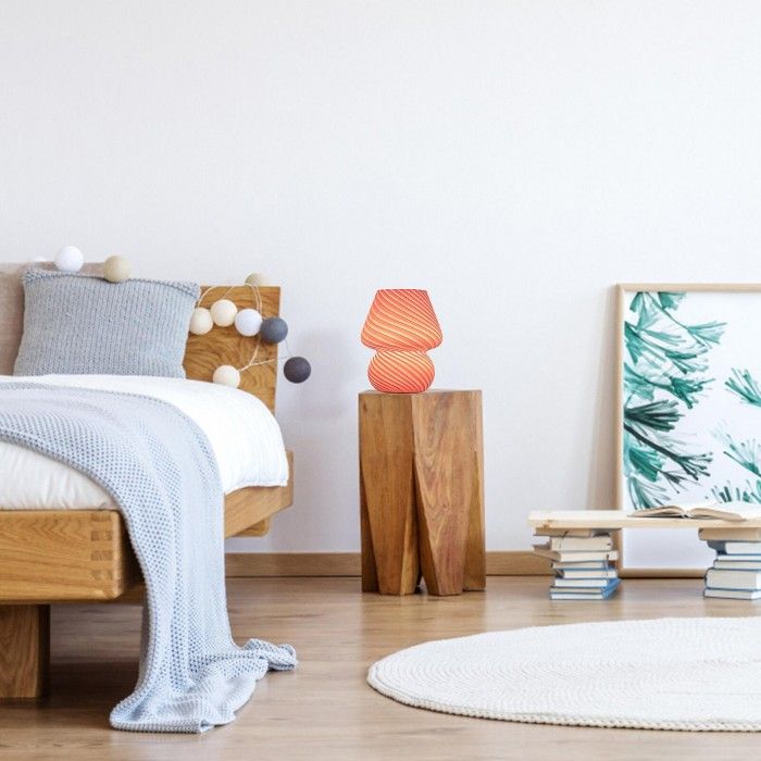 a bedroom with white walls and wooden furniture