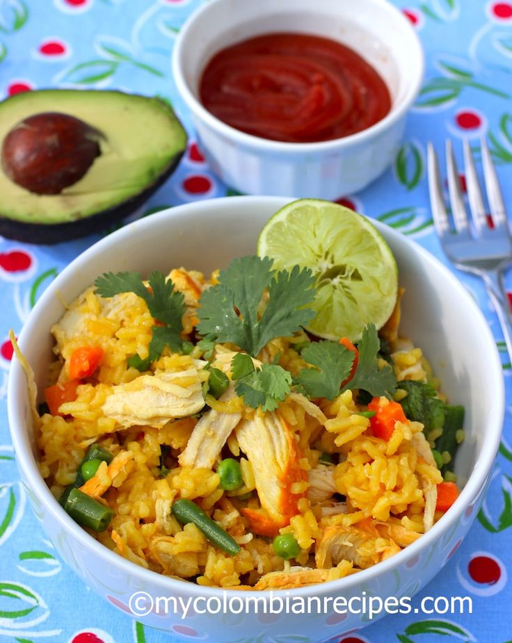 a bowl filled with rice and vegetables next to an avocado