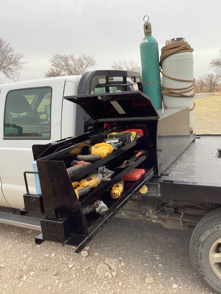 a white truck with tools in the back