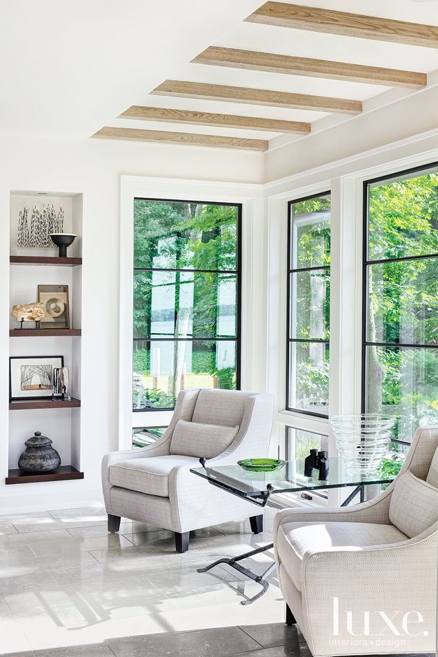 a living room filled with furniture and windows