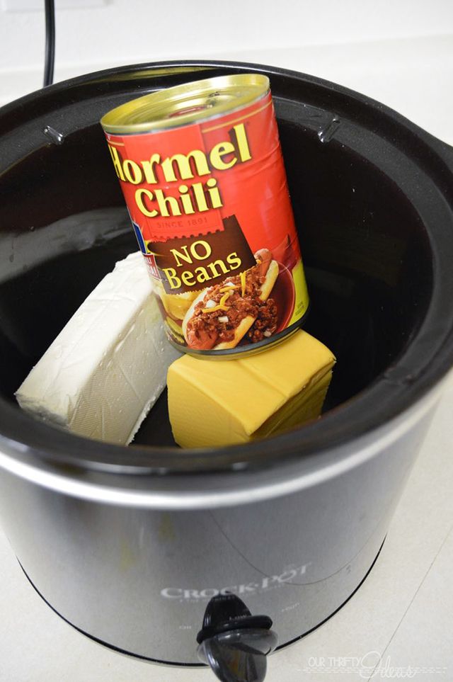 a can of chili and cheese in a crock pot with other food items inside