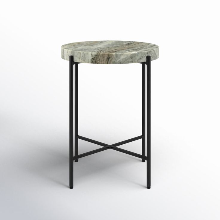 a round marble table with metal legs on an isolated white background, the top is black