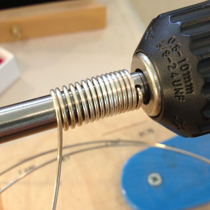 an electric drill is being used on a piece of wood