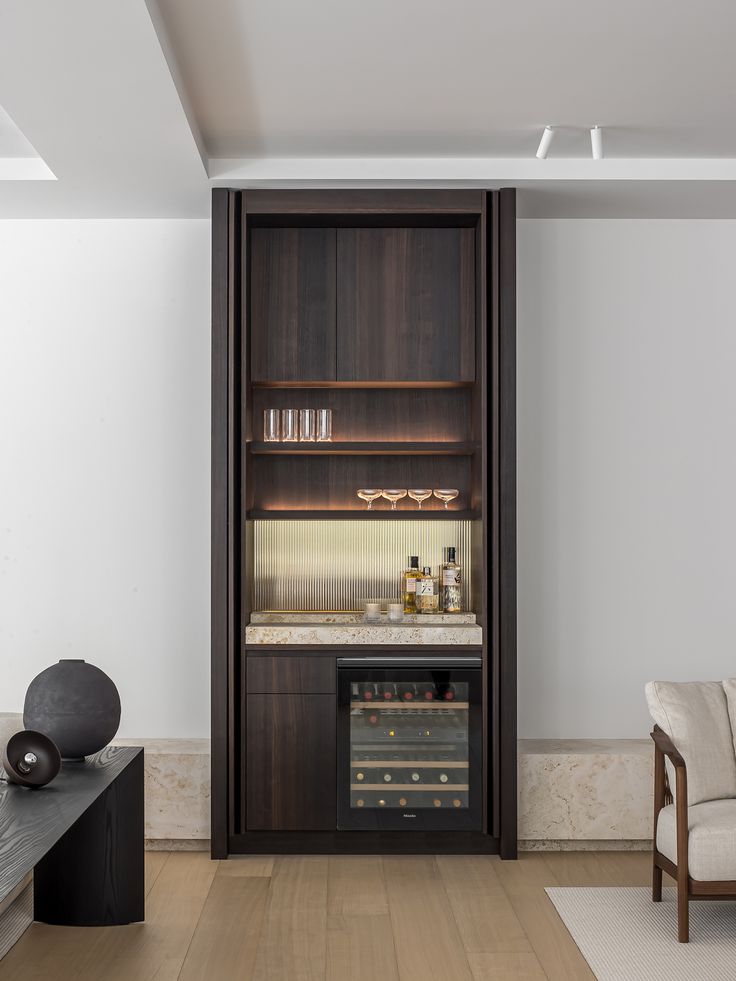 a living room with some chairs and a book shelf