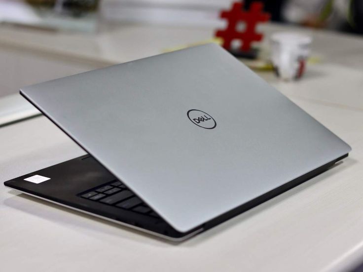 a laptop computer sitting on top of a white table