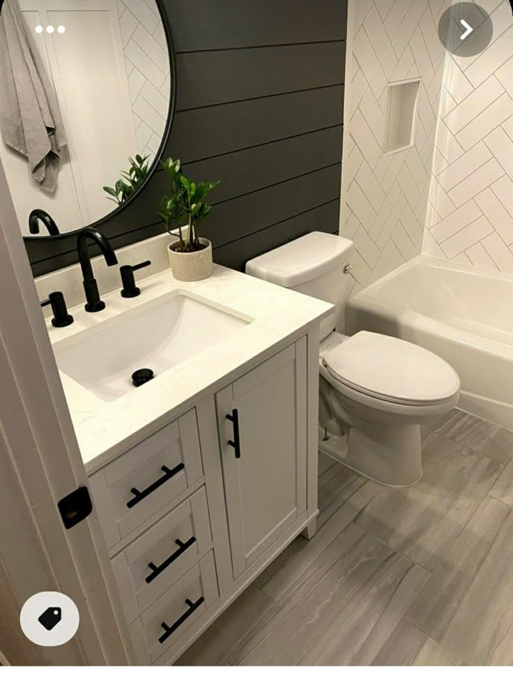 a bathroom with a toilet, sink and bathtub