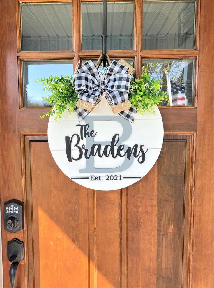 a wooden door with a sign that says the braaches on it and a bow