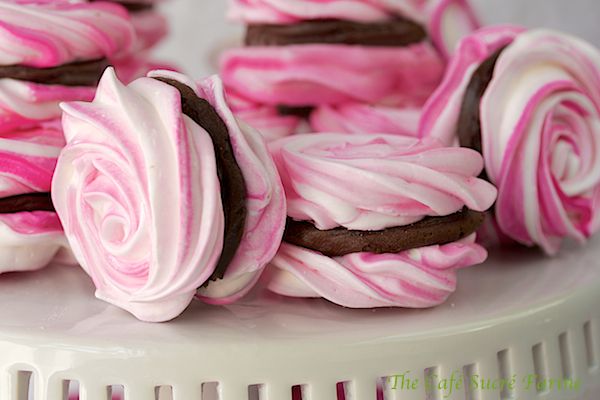 pink and white desserts on a plate with the words i love you written above them