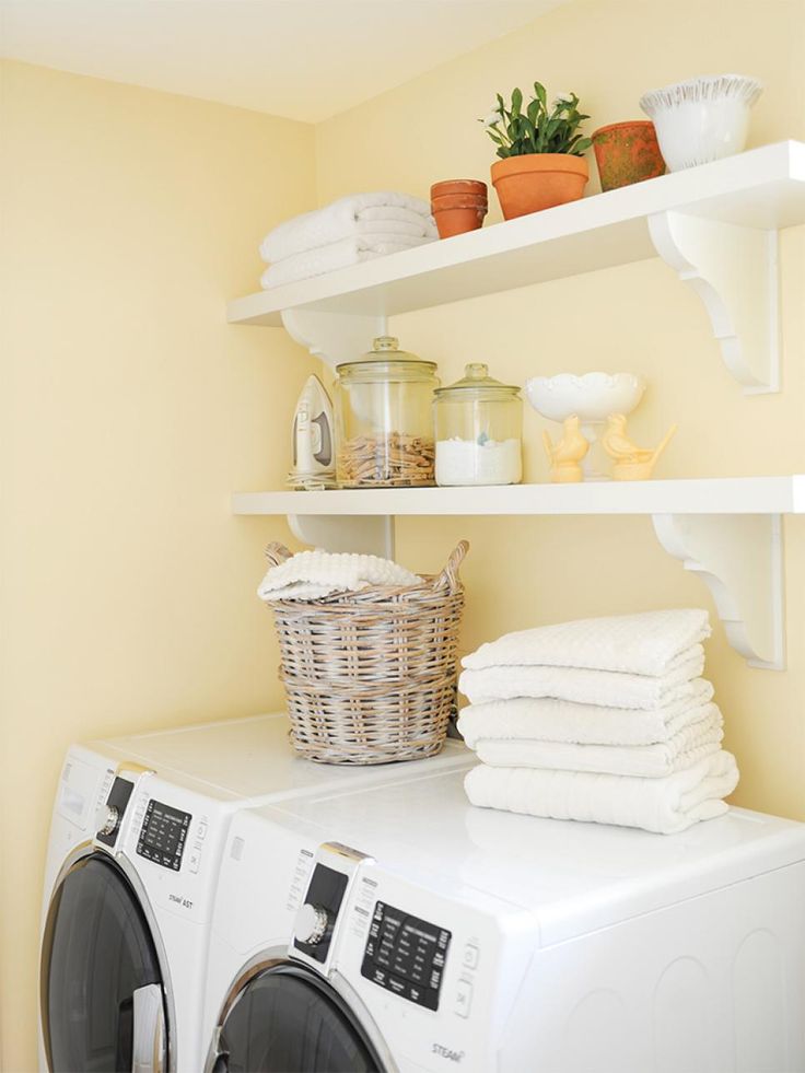 a washer and dryer sitting next to each other in a room with yellow walls