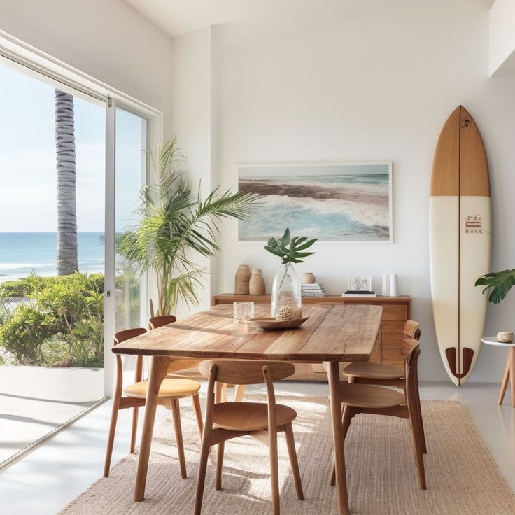 a dining room with a surfboard on the wall and a wooden table surrounded by chairs