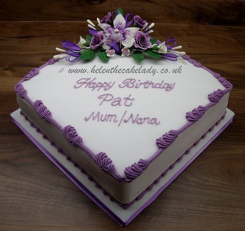 a birthday cake with purple frosting and flowers on top that says happy birthday pa & mum nana