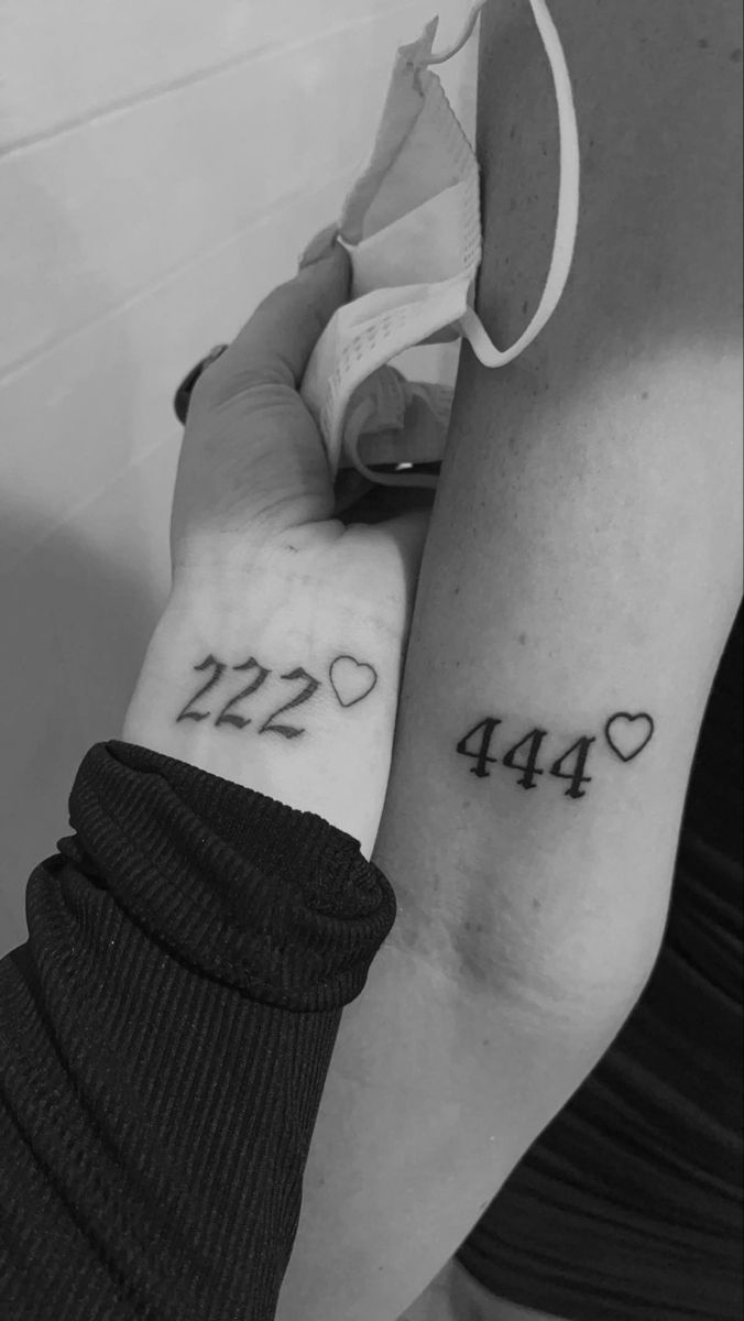 two people with tattoos on their arms holding each other's hands and the number twenty four