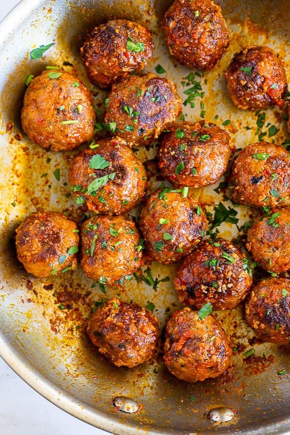 meatballs in a pan with parsley on top