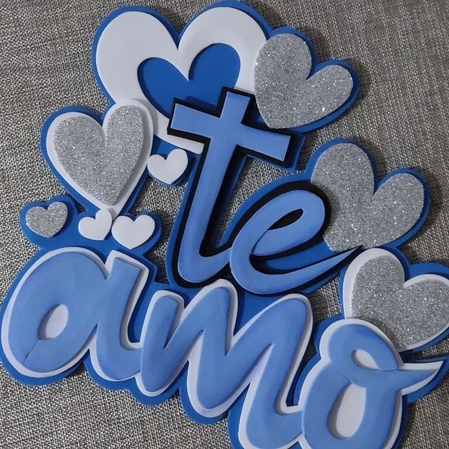 blue and white magnets with the word love spelled in large letters on a gray surface