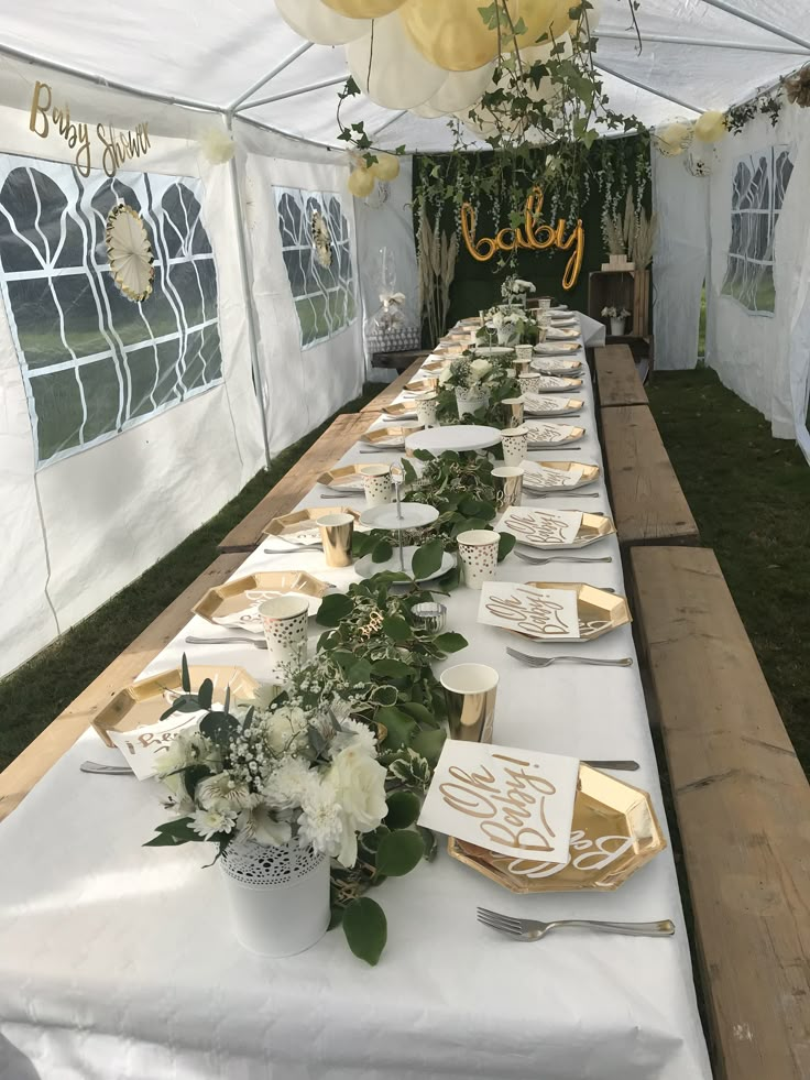 a long table is set up with plates and napkins for guests to eat at