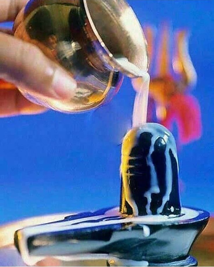 a person pouring liquid into a cup from a faucet