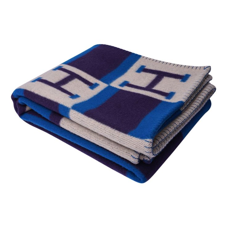 two blankets folded on top of each other in blue and white colors, with the same pattern