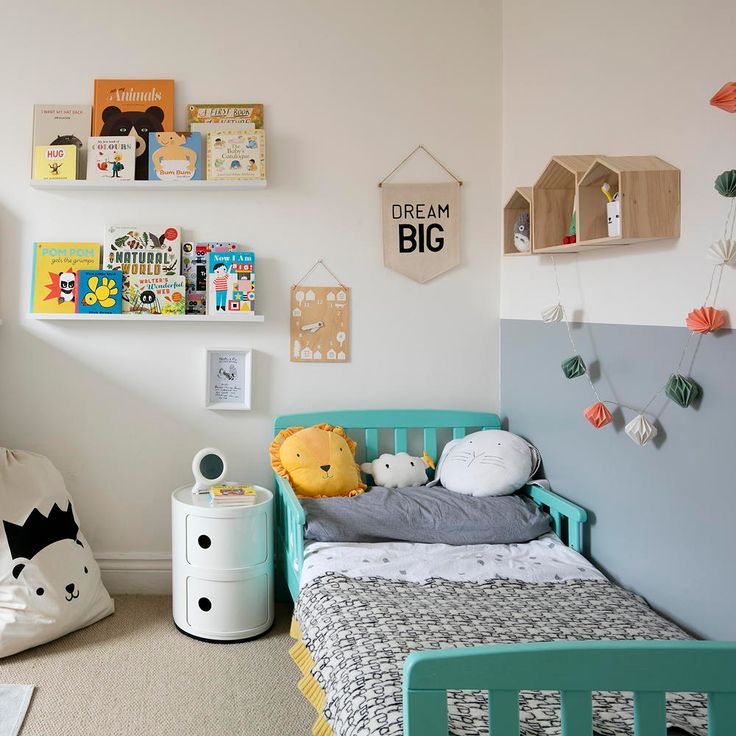 a child's bedroom with toys and decor on the wall