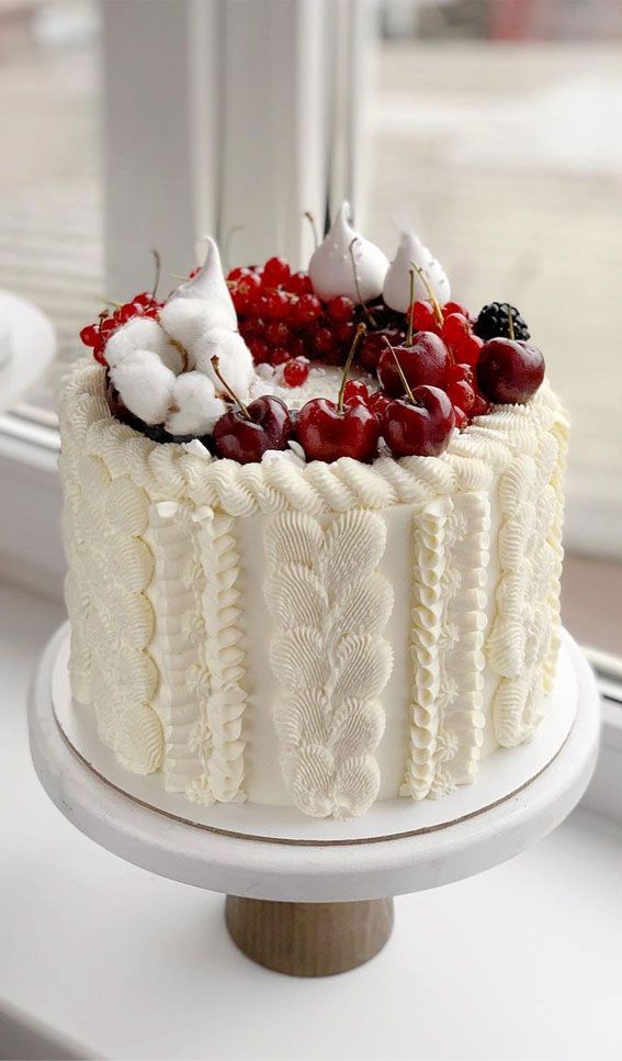 a white cake sitting on top of a window sill