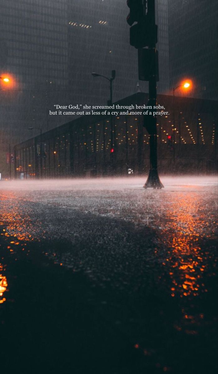 a city street at night in the rain with a traffic light and quote about it