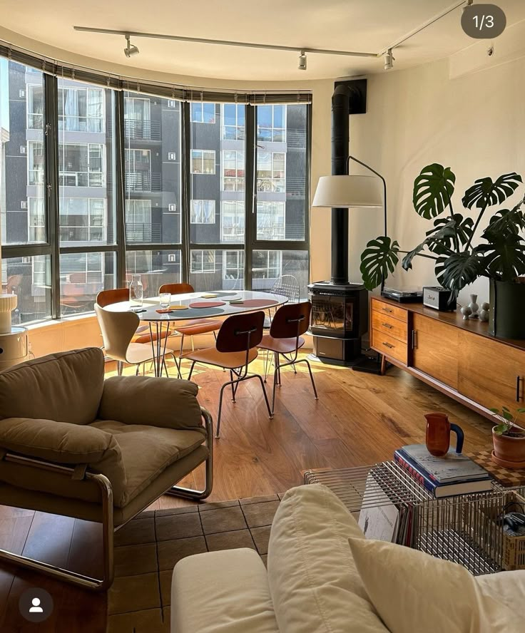 a living room filled with furniture and large windows