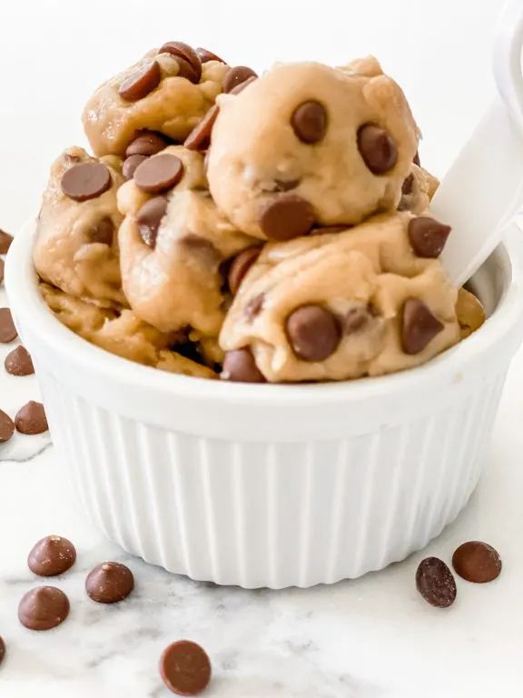 chocolate chip cookies in a white bowl with text overlay that reads edible cookie dough