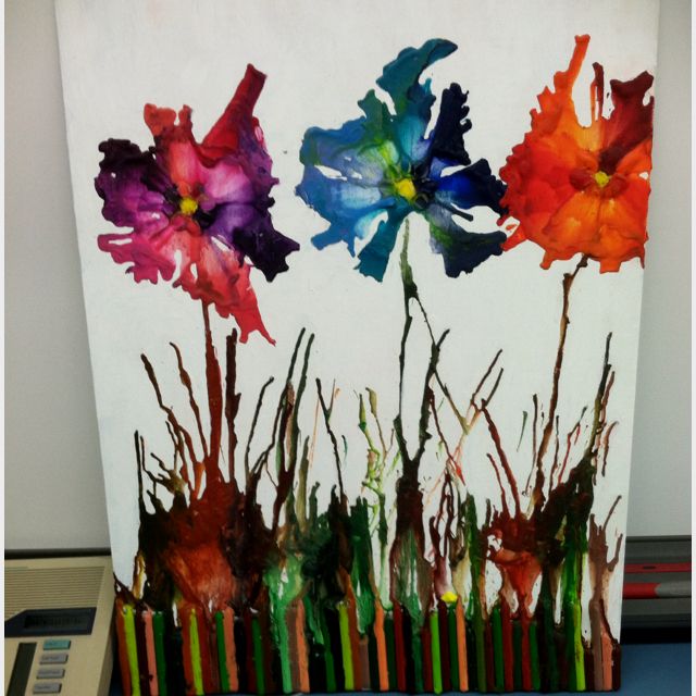 three colorful flowers painted on a white canvas