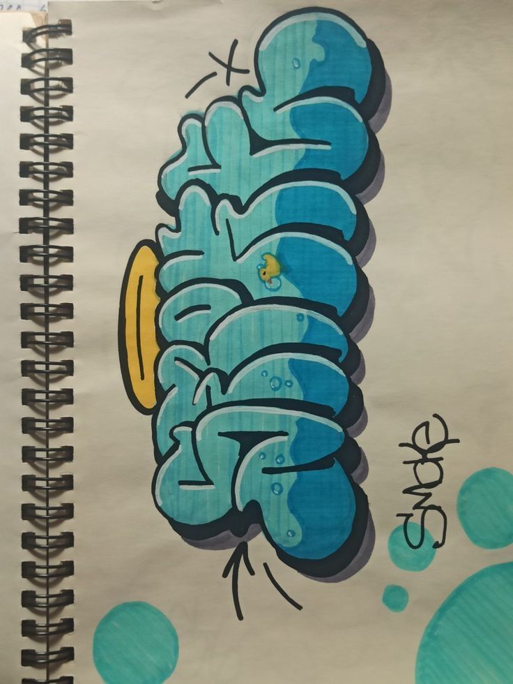 a spiral notebook with blue graffiti on it