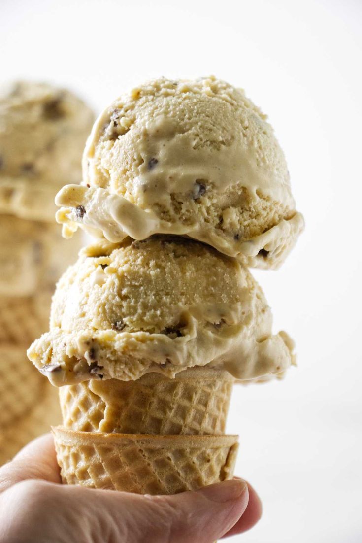 three scoops of ice cream are stacked on top of each other in an ice cream cone