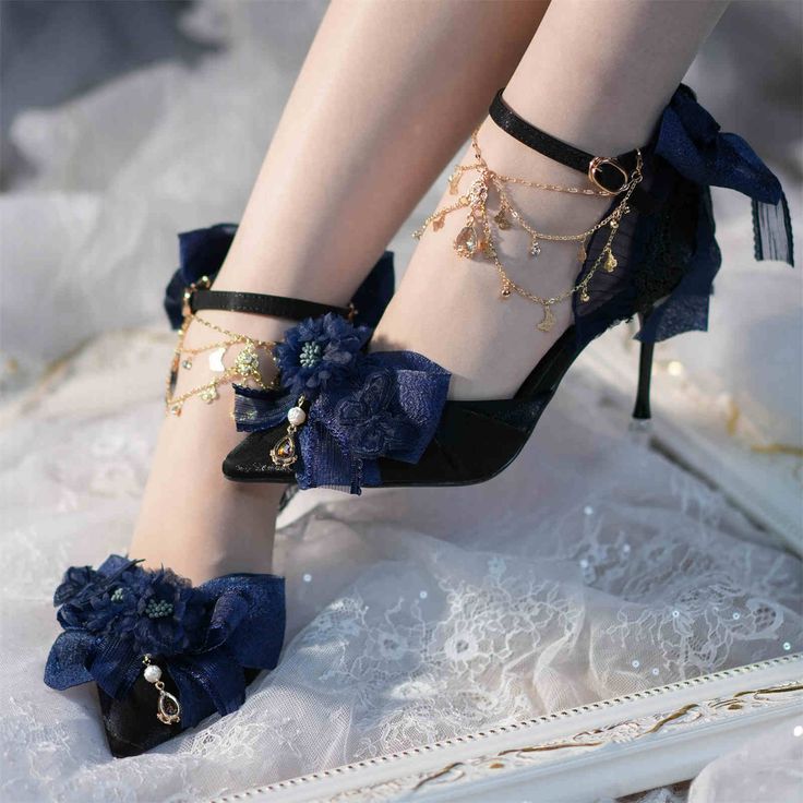 Step into a world of elegance and charm with these exquisite pointed-toe heels. Designed with a sleek stiletto heel, these shoes are adorned with a floral bow on the upper, adding a touch of feminine allure. Delicate butterfly appliqués enhance the whimsical elegance of the design. The heel features heart-shaped and bow appliqués, completing the look with a playful yet sophisticated bow detail. Perfect for adding a touch of romance and style to any outfit, these heels are a must-have for those w High Heel Design, Blue Heels Aesthetic, Fantasy Shoes Heels, Blue Butterfly Heels, Blue Shoes Aesthetic, Dark Blue High Heels, Celestial Shoes, Ball Heels, Shoes For Prom