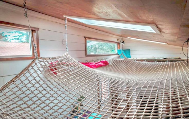 a hammock hanging from the ceiling in a room