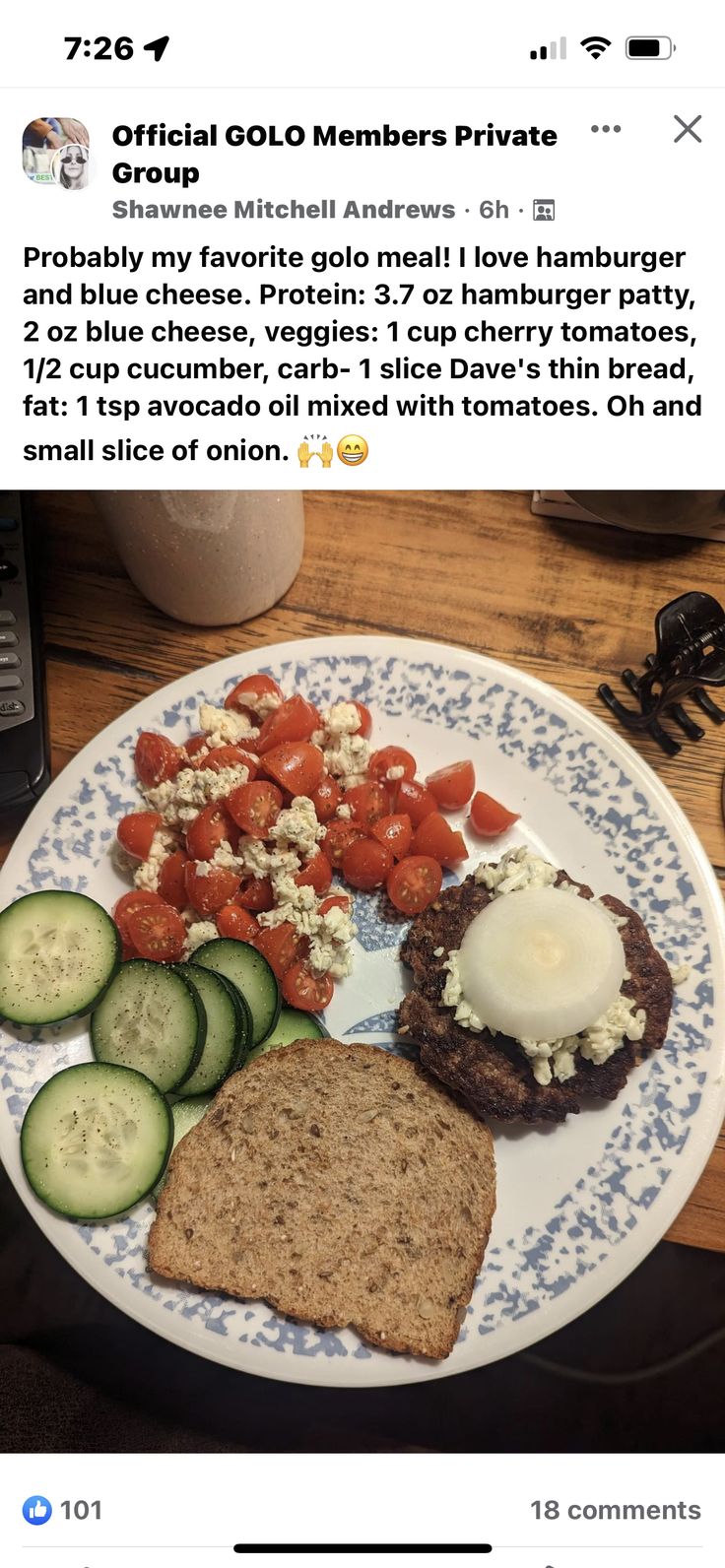 a white plate topped with meat and veggies on top of a wooden table