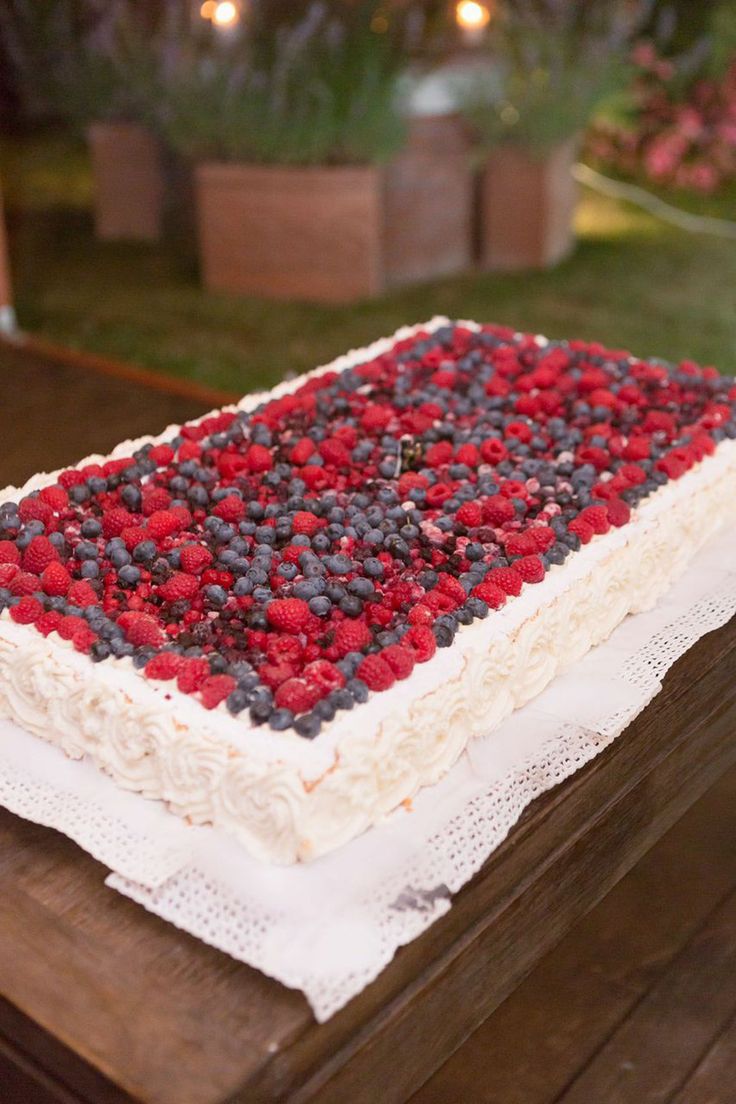 a cake with red, white and blue frosting sitting on top of a wooden table