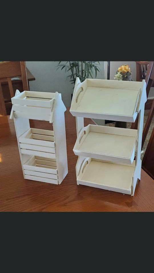 two white shelves sitting on top of a wooden table