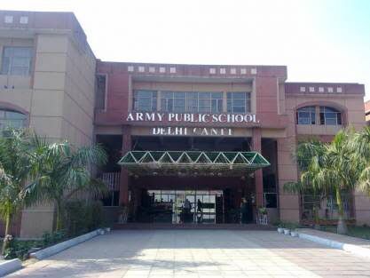 an army public school building with palm trees in the foreground and large windows on the front