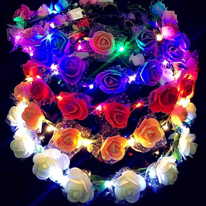 multicolored roses with lights on them are arranged in the shape of a heart