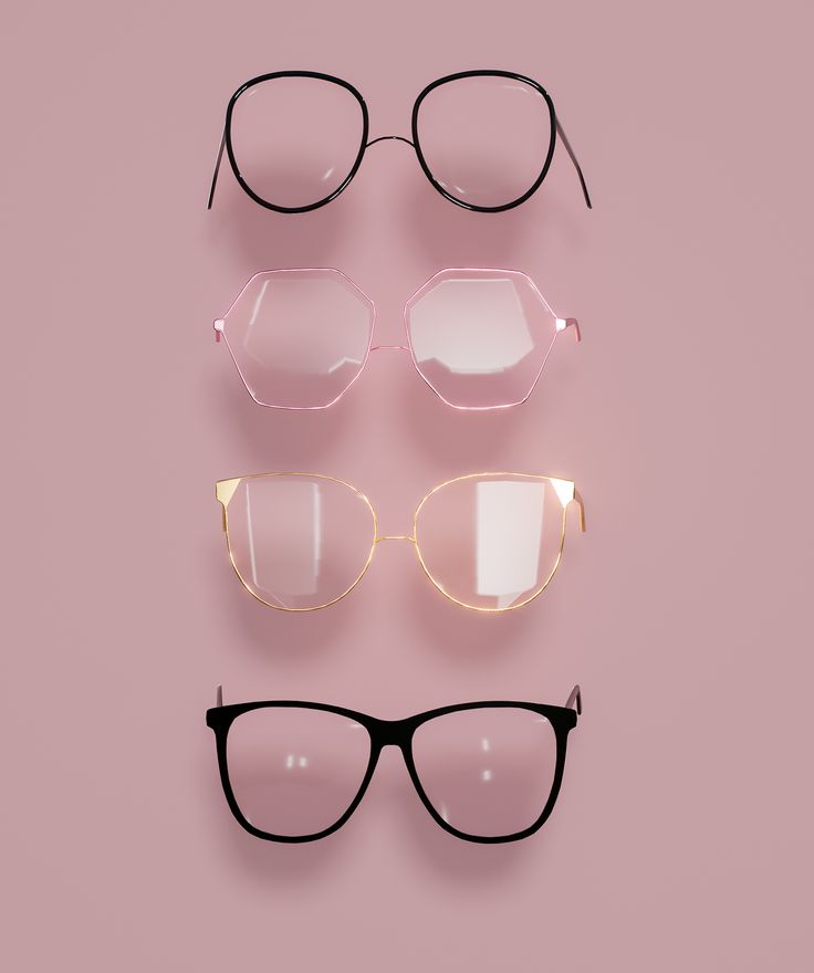 three pairs of glasses sitting on top of a pink surface with black frames and clear lenses