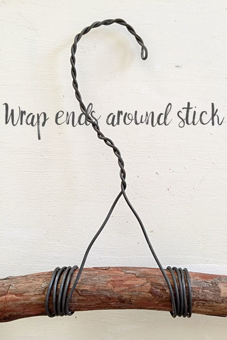 a piece of wire hanging from a wooden stick with the words wrap end around stick