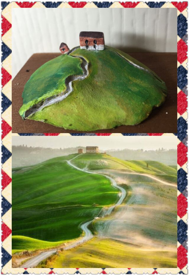 a green hill covered in grass next to a red and white checkered table cloth