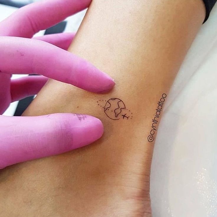 a woman's foot with a small tattoo on the left side of her leg